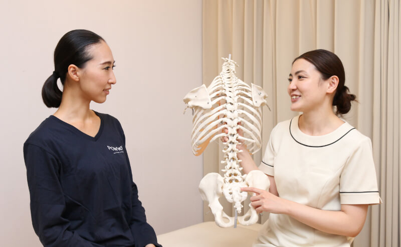 写真:スタッフとお客様が施術部屋で座って話している